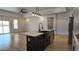 Kitchen island featuring a black faucet, farmhouse sink, and room for storage at 11612 S 211Th Ln, Buckeye, AZ 85326