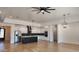 Open-concept kitchen with a large island, stainless steel refrigerator, and modern pendant lighting at 11612 S 211Th Ln, Buckeye, AZ 85326