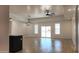 Bright open-concept living space with lots of light, ceiling fan, and sliding glass doors at 11612 S 211Th Ln, Buckeye, AZ 85326