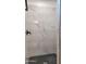 Modern shower featuring white marble-look tiles and a hexagon mosaic floor at 11612 S 211Th Ln, Buckeye, AZ 85326