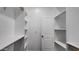Walk-in closet with white shelves and a white door at 11612 S 211Th Ln, Buckeye, AZ 85326