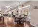 Cozy dining area features a decorative hanging light, rich wood floors, and shutters for natural light control at 12423 W Fieldstone Dr, Sun City West, AZ 85375