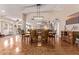 Bright dining room with parquet flooring, a large table, and a stylish light fixture for comfortable gatherings at 12423 W Fieldstone Dr, Sun City West, AZ 85375