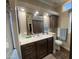 Bathroom boasts a dark vanity, and large mirror reflecting the closet for optimal space at 1277 S Shawnee Dr, Apache Junction, AZ 85119
