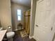 Cozy bathroom with decorative rug, shower, and small side table next to a window at 1277 S Shawnee Dr, Apache Junction, AZ 85119