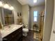 Well-lit bathroom featuring decorative rug, shower, side table, and large vanity with mirror at 1277 S Shawnee Dr, Apache Junction, AZ 85119