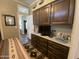 Bedroom with built-in dresser, cabinets, and decorative rug, offering ample storage space at 1277 S Shawnee Dr, Apache Junction, AZ 85119