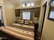 Bedroom featuring a comfortable bed, bedside tables, and a window with blinds for natural light at 1277 S Shawnee Dr, Apache Junction, AZ 85119