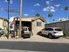 Charming tan single Gathering home featuring well-maintained landscaping, a driveway and American flag at 1277 S Shawnee Dr, Apache Junction, AZ 85119