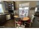 Kitchen and eating area with wood table and chairs and stainless-steel appliances under natural light at 1277 S Shawnee Dr, Apache Junction, AZ 85119
