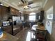 Spacious kitchen with stainless steel appliances, a ceiling fan, and abundant cabinet space at 1277 S Shawnee Dr, Apache Junction, AZ 85119