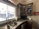 Well-lit kitchen featuring ample cabinet space, a stainless steel sink, and a modern faucet at 1277 S Shawnee Dr, Apache Junction, AZ 85119