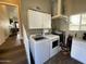 Convenient laundry room featuring modern washer and dryer units with cabinets at 1277 S Shawnee Dr, Apache Junction, AZ 85119