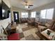 Bright living room featuring a plush sofa, recliner chairs, and natural light from large windows at 1277 S Shawnee Dr, Apache Junction, AZ 85119