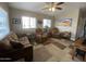 Cozy living room with ample seating, a ceiling fan, and sunlit windows creating a relaxing atmosphere at 1277 S Shawnee Dr, Apache Junction, AZ 85119