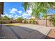 Spacious backyard featuring a stone patio and brick wall surround at 1280 E Redwood Dr, Chandler, AZ 85286