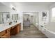 Bright bathroom features a dual sink vanity, spacious bathtub, and a closet with mirrored doors at 1280 E Redwood Dr, Chandler, AZ 85286