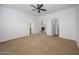 Spacious bedroom with a ceiling fan, neutral carpet, and two entryways at 1280 E Redwood Dr, Chandler, AZ 85286