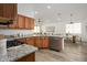 Stylish kitchen features granite countertops, stainless steel appliances, and a seamless view into the dining and living areas at 1280 E Redwood Dr, Chandler, AZ 85286
