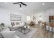 Open-concept living room flows into a dining area, with light wood floors and modern decor throughout the space at 1280 E Redwood Dr, Chandler, AZ 85286