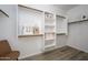 Spacious walk-in closet with custom shelving and wooden rods to maximize storage at 1280 E Redwood Dr, Chandler, AZ 85286