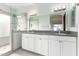 Bright bathroom featuring double sink vanity, modern lighting, and glass enclosed walk-in shower at 13375 N 96Th Pl, Scottsdale, AZ 85260