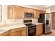 Well-equipped kitchen featuring stainless steel appliances and wood cabinetry at 13375 N 96Th Pl, Scottsdale, AZ 85260