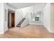 Bright open-plan living area with stairs, stylish chandelier and laminate floors at 13375 N 96Th Pl, Scottsdale, AZ 85260