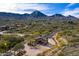 Aerial view of the neighborhood entrance featuring a stone gate surrounded by a mountain backdrop at 16856 N Mountain Pkwy, Fountain Hills, AZ 85268