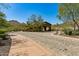 Community entrance features a stone gate surrounded by native desert plants and trees at 16856 N Mountain Pkwy, Fountain Hills, AZ 85268