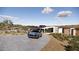 A sprawling driveway leads up to the modern residence, surrounded by natural desert landscaping and distant mountains at 16856 N Mountain Pkwy, Fountain Hills, AZ 85268