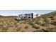 A modern home perched on a hill features clean lines and seamlessly blends with the arid landscape at 16856 N Mountain Pkwy, Fountain Hills, AZ 85268