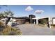Modern exterior features a bridge over the driveway, a glass garage door and drought-resistant landscaping at 16856 N Mountain Pkwy, Fountain Hills, AZ 85268