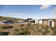 Modern home exterior with a desert landscape, blue sky, and a car parked in front at 16856 N Mountain Pkwy, Fountain Hills, AZ 85268