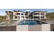 Backyard featuring a pool with waterfall feature, lounge chairs, and seating area at 16856 N Mountain Pkwy, Fountain Hills, AZ 85268