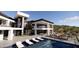 Gorgeous backyard features a pool, lounge chairs, outdoor seating area with fireplace, and mountain views at 16856 N Mountain Pkwy, Fountain Hills, AZ 85268
