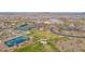 Expansive aerial view showcasing the community's amenities: tennis courts, a lake, and more at 18059 W Tanglewood Dr, Goodyear, AZ 85338