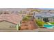 Aerial view showing the backyard with desert landscaping and nearby pool at 18059 W Tanglewood Dr, Goodyear, AZ 85338