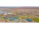Community aerial view featuring pickleball courts, putting green, lake and clubhouse with parking, and beautiful Arizona desert landscape at 18059 W Tanglewood Dr, Goodyear, AZ 85338