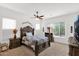 Cozy bedroom showcasing a ceiling fan, large window and classic furnishings that create a relaxing atmosphere at 18059 W Tanglewood Dr, Goodyear, AZ 85338