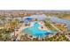 Aerial view of the community pool offering lounge seating, shade and lake views, perfect for relaxation at 18059 W Tanglewood Dr, Goodyear, AZ 85338