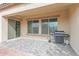 Back patio is covered and features tile flooring, a barbeque grill, and backyard views at 18059 W Tanglewood Dr, Goodyear, AZ 85338