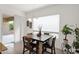 Bright dining area with a modern table, neutral wall paint, and a sliding glass door to the backyard at 18059 W Tanglewood Dr, Goodyear, AZ 85338