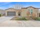 Charming single-story home with a two-car garage, desert landscaping, and a welcoming facade at 18059 W Tanglewood Dr, Goodyear, AZ 85338