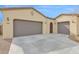 Spacious three-car garage with long driveway offers convenience and ample parking, enhancing the home's exterior appeal at 18059 W Tanglewood Dr, Goodyear, AZ 85338