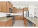 Spacious kitchen with stainless steel appliances, granite countertops, and beautiful wood cabinets at 18059 W Tanglewood Dr, Goodyear, AZ 85338