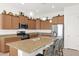 A gourmet kitchen featuring granite countertops, stainless steel appliances, and a convenient kitchen island with seating at 18059 W Tanglewood Dr, Goodyear, AZ 85338
