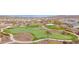 Aerial view of a community putting green, showcasing the lush landscaping and inviting common areas at 18059 W Tanglewood Dr, Goodyear, AZ 85338