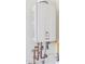 Rinnai tankless water heater mounted on a wall with visible plumbing connections at 18059 W Tanglewood Dr, Goodyear, AZ 85338