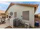 Backyard patio featuring outdoor seating, landscaping, and a home air conditioning unit at 20615 N 105Th Ave, Peoria, AZ 85382